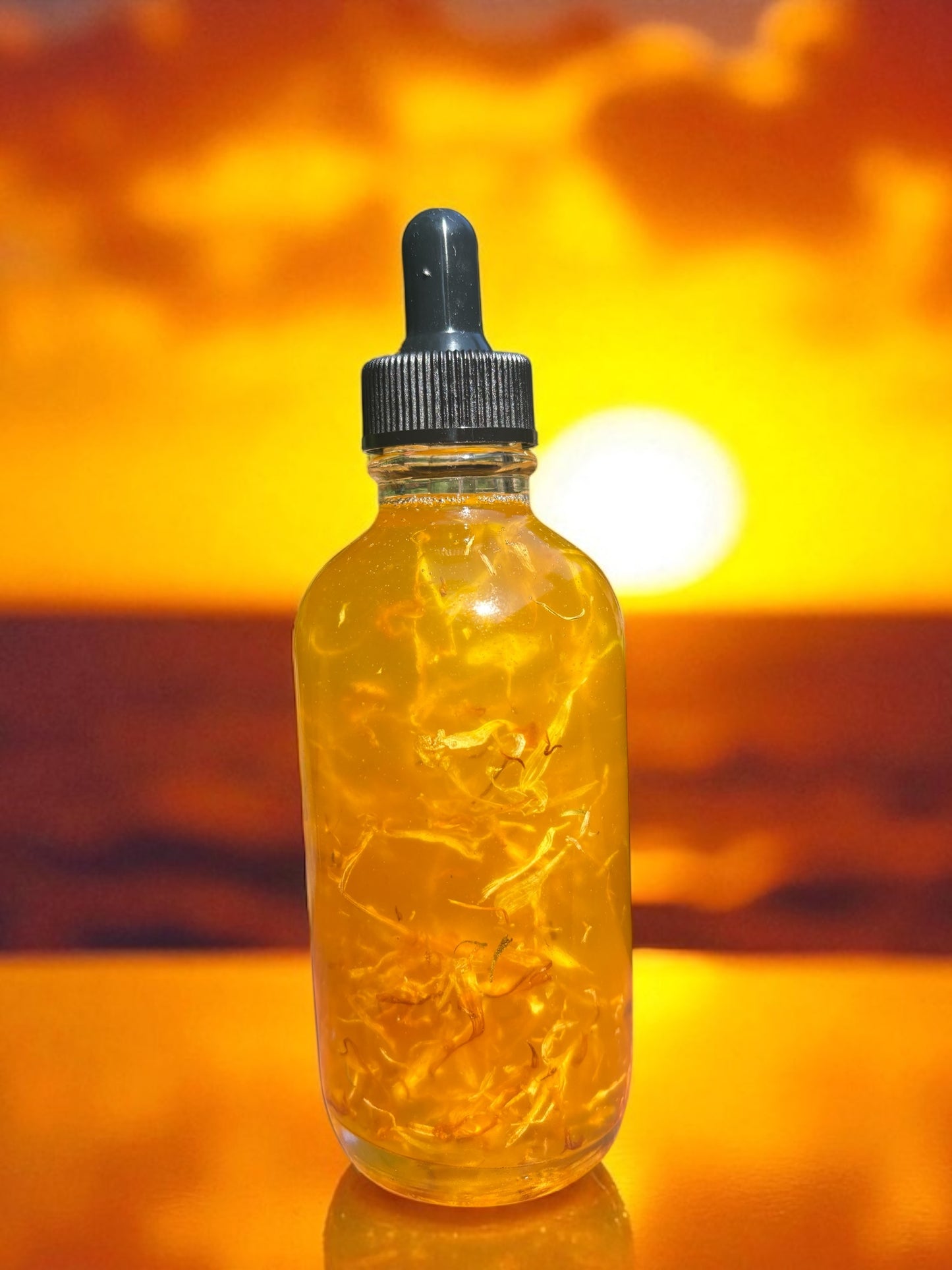 Bottle of yellow liquid with a dropper against a sunset sky